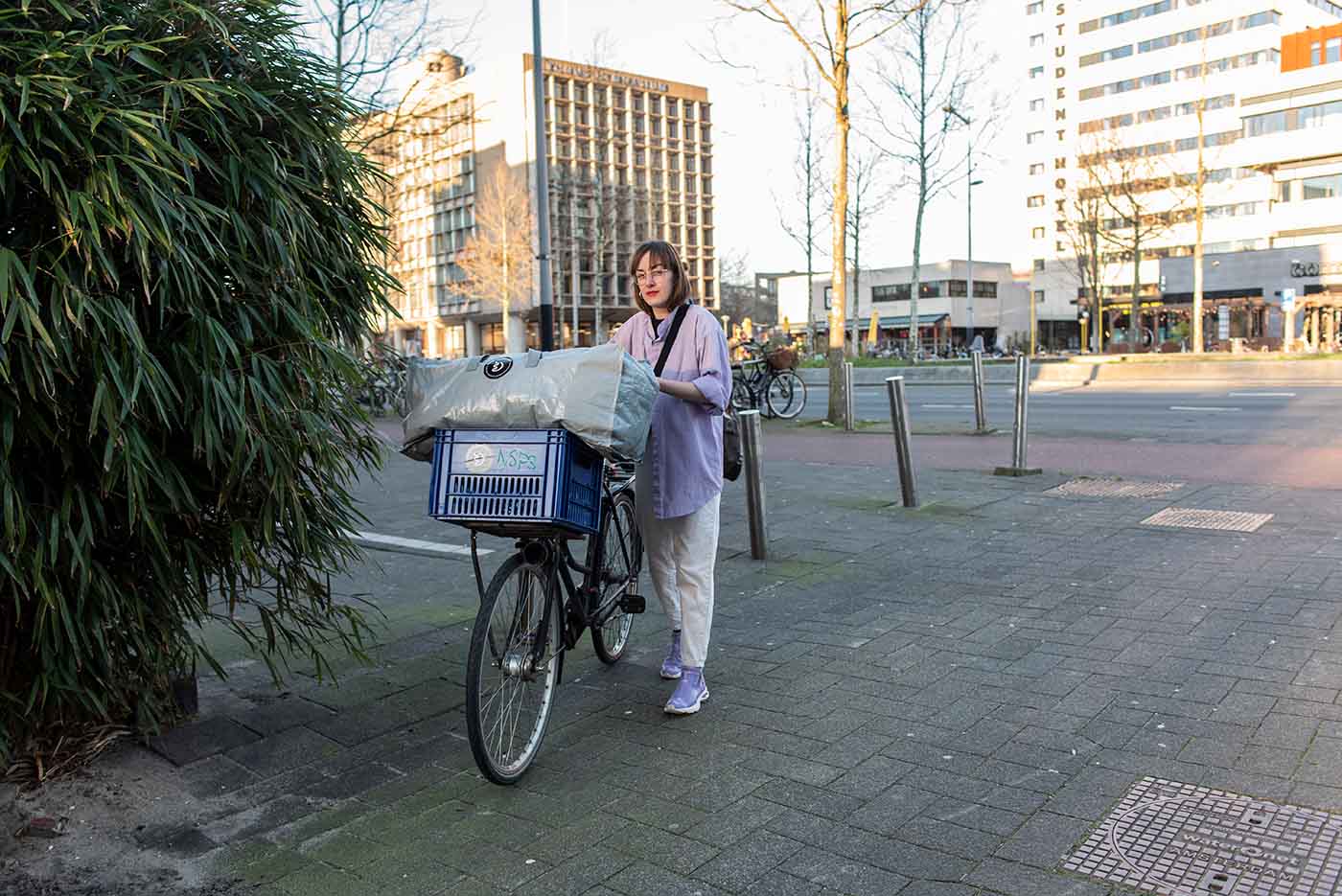 Zsofia Kollar on her bike with a bag of human hair waste